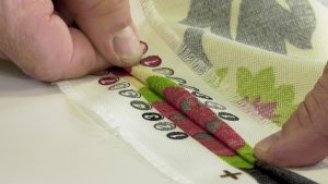 Two fabric panels aligned with matching patterns, pinned and ready to sew together.