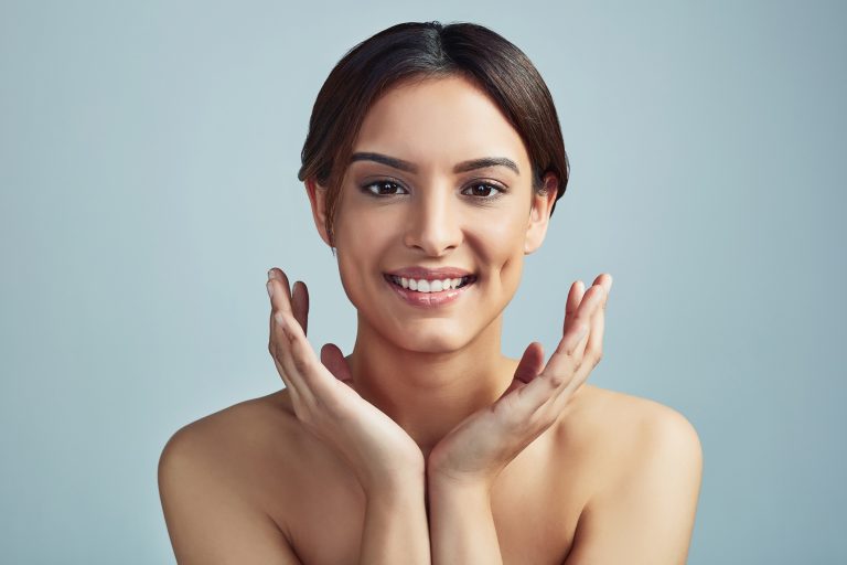 Close-up of a clear, radiant female face with smooth skin and minimal visible pores
