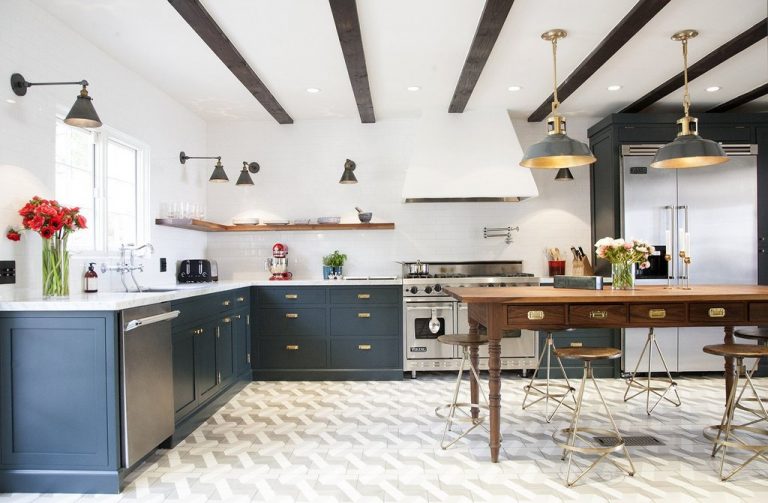 A kitchenette featuring colorful handmade cement tiles on the backsplash and floor.