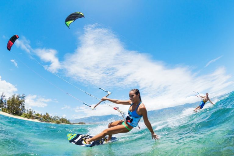 People enjoying various water sports like paddleboarding, kayaking, and tubing