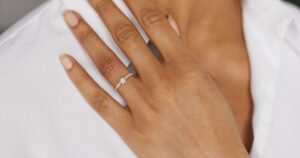 A delicate 0.3ct diamond engagement ring set in intricate gold, inspired by Indian royal designs.